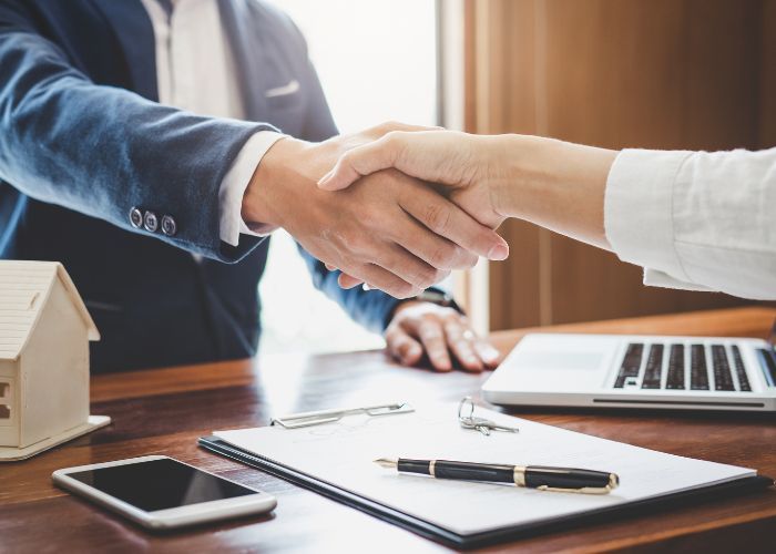 Handshake over paperwork agreement